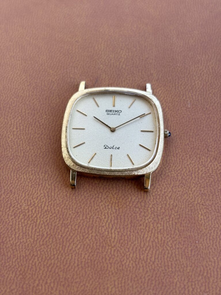 Vintage Seiko Dolce 6730-5170. Gold and creme. Brown background